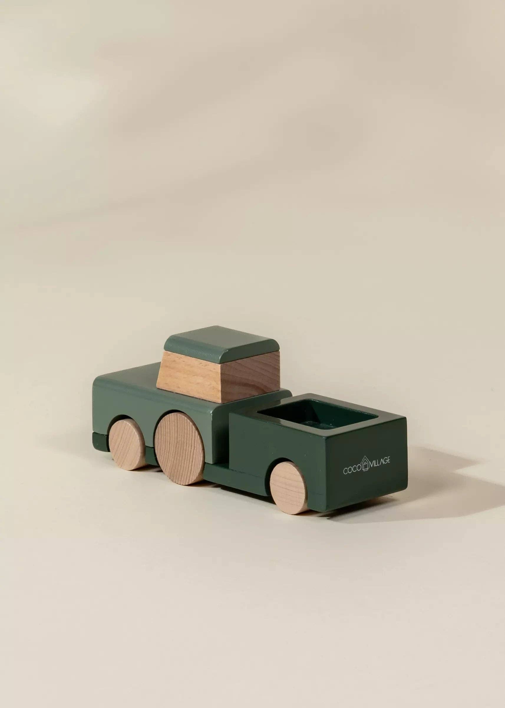 Wooden toy truck with a gradient color scheme on a beige background