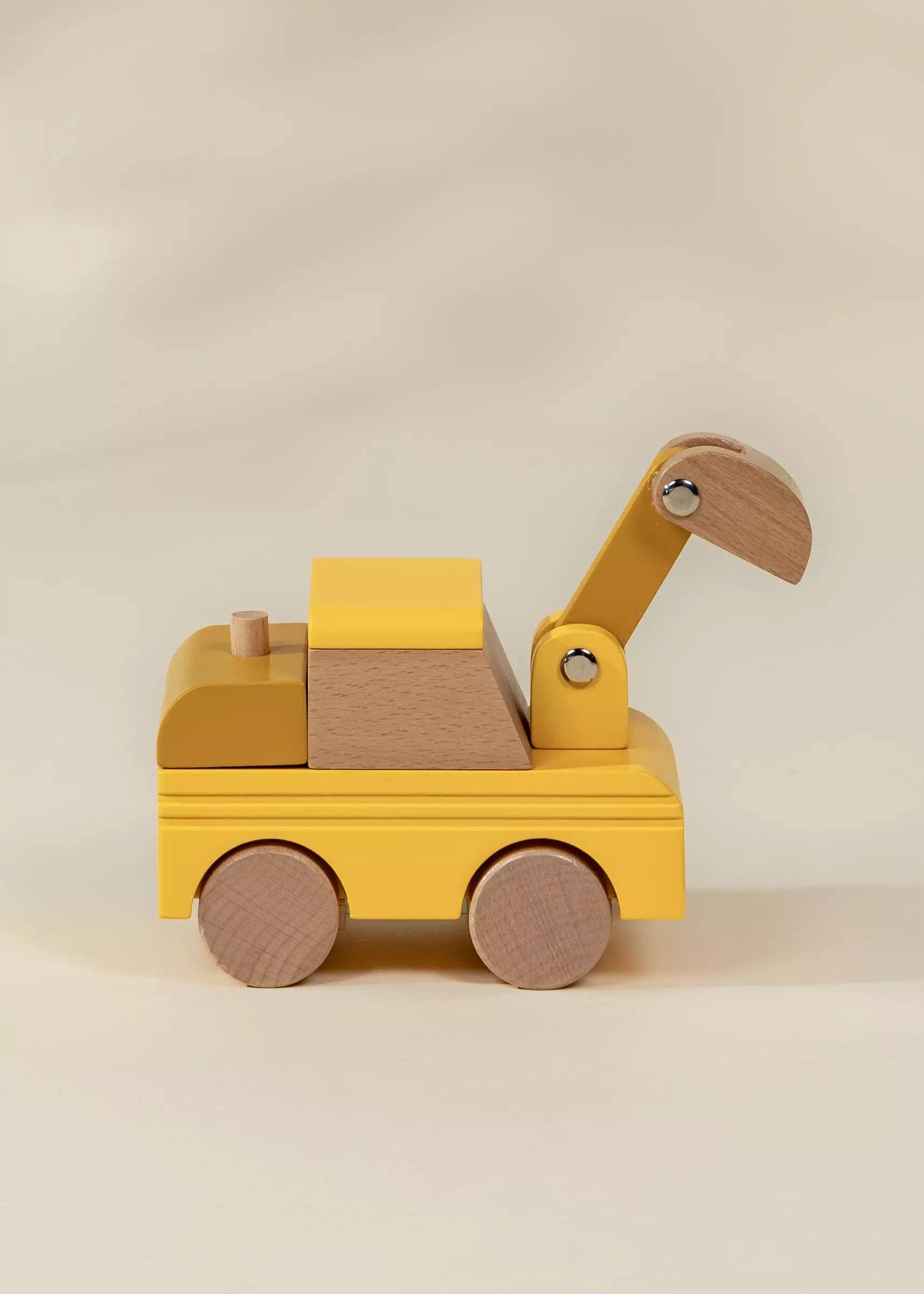 Wooden toy crane on a beige background