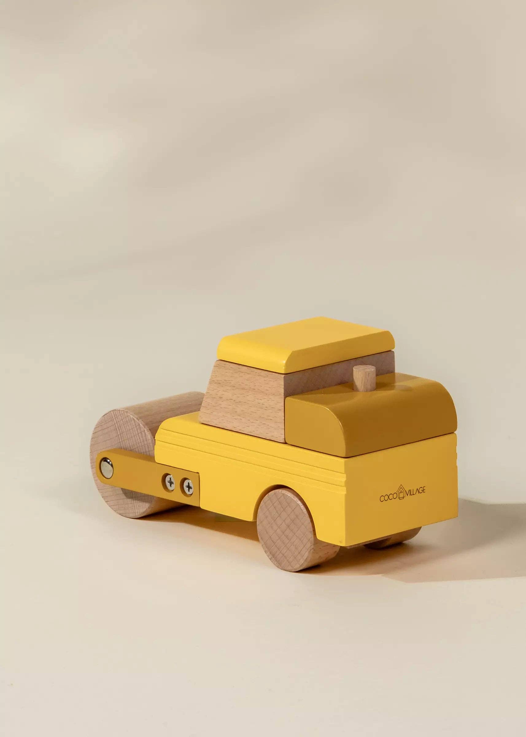 Yellow toy truck with wooden accents on a beige background