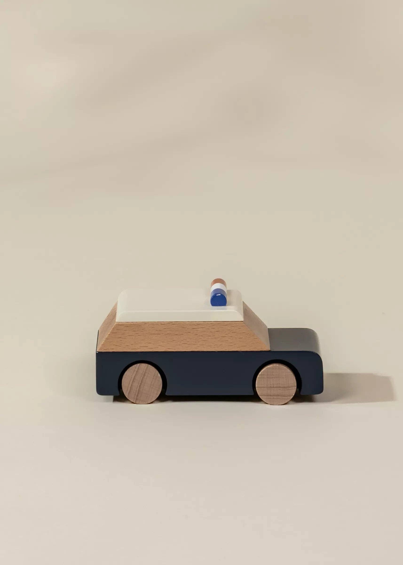 Wooden toy car on a beige background