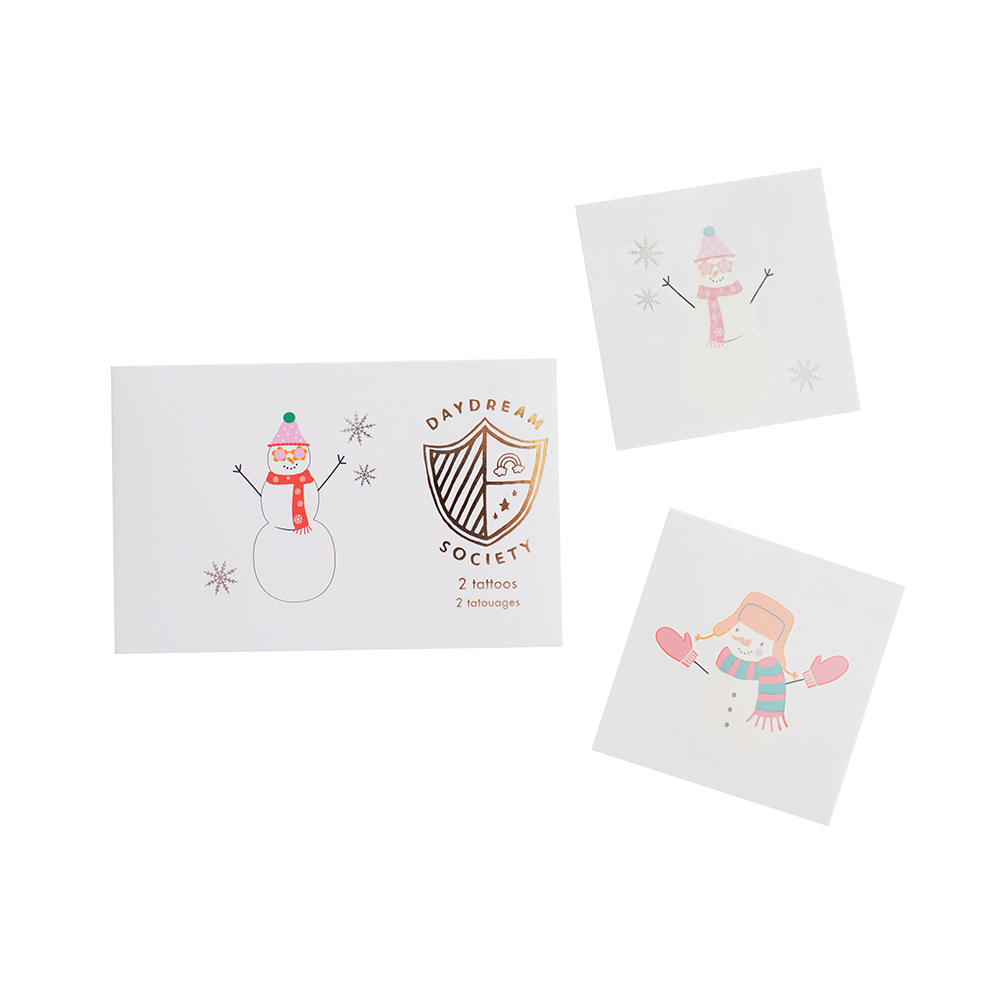 Three square white art prints featuring winter-themed illustrations of snowmen and snowflakes, arranged on a plain white background. One print shows a snowman with a red scarf and green hat, another shows a snowman with pink details, and the third shows a snowman with orange hair and pink mittens.