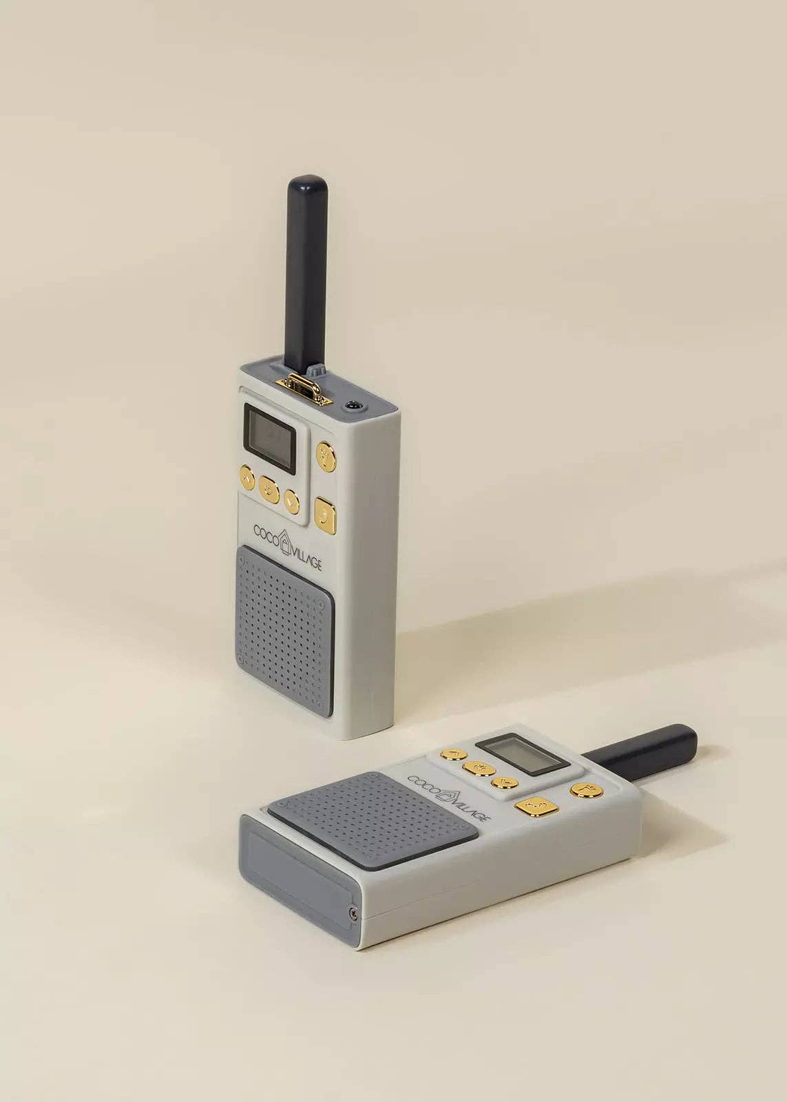 Two gray walkie-talkies on a beige background