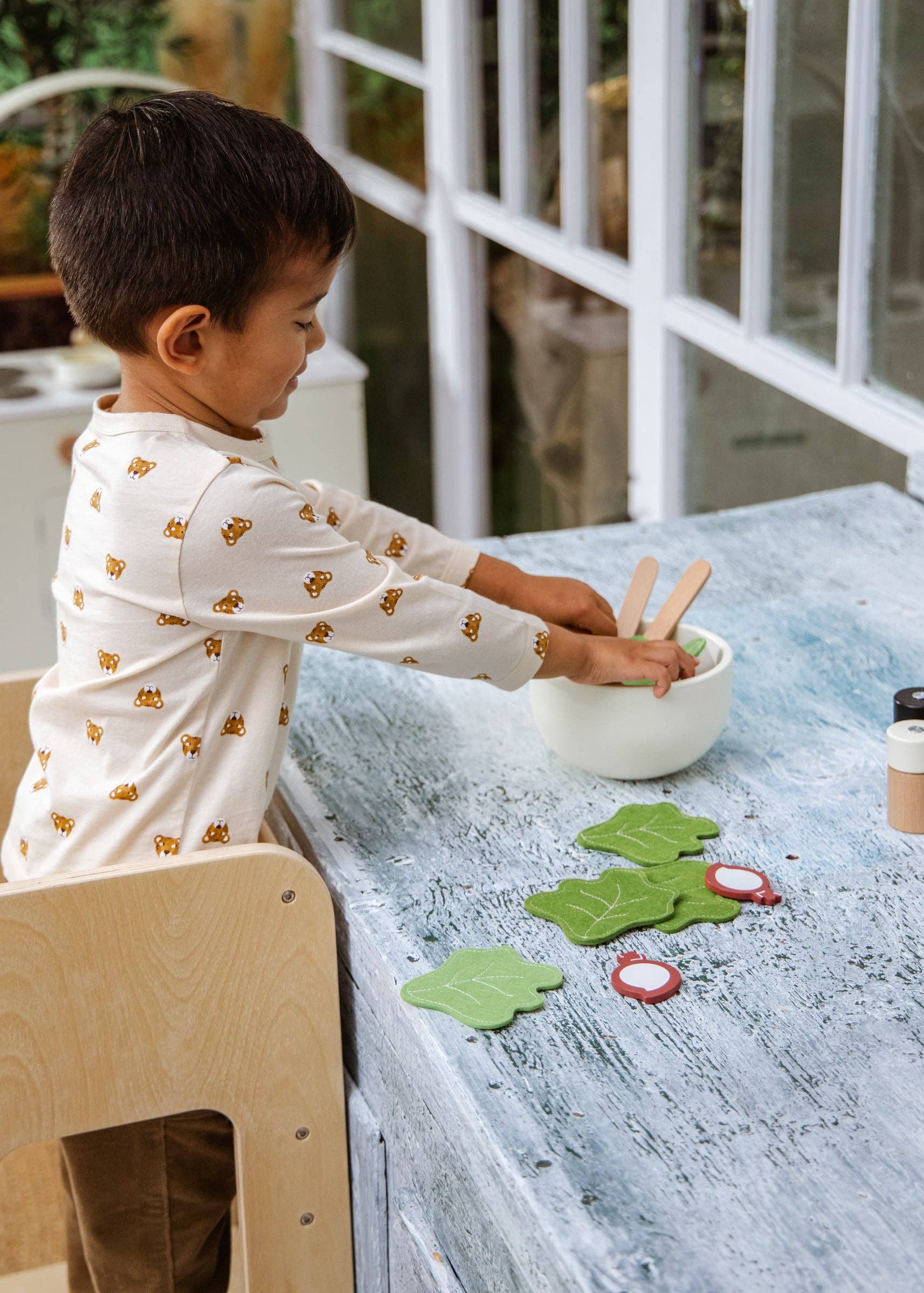 Child playing with educational toys at a table indoors