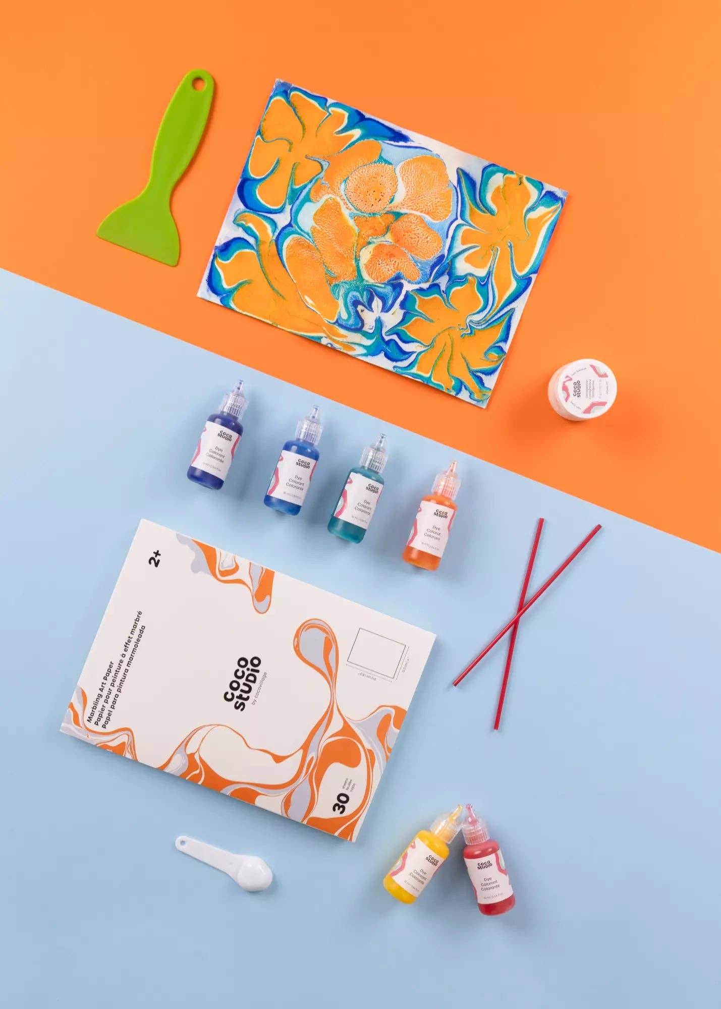 Color mixing set with bottles, a palette, and tools on a blue and orange background