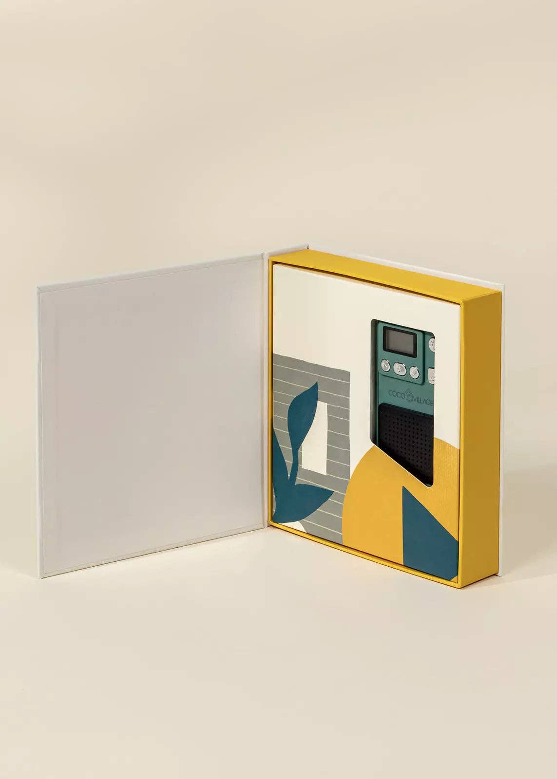 Yellow box with a small electronic device inside on a beige background
