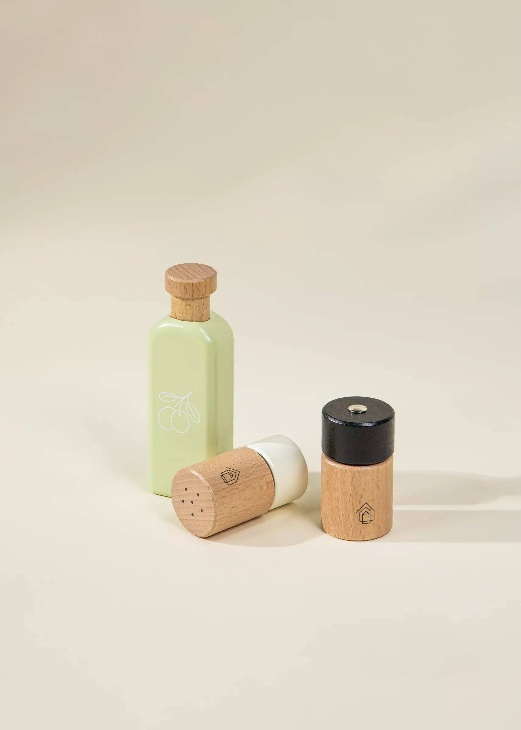Set of three decorative bottles with wooden and ceramic designs on a beige background
